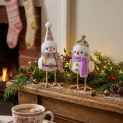 Red white and grey Christmas felt bird figurines in a cozy holiday living room scene
