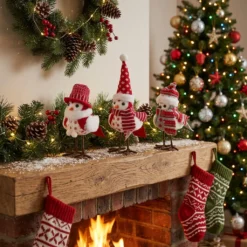 Red white and grey Christmas felt bird figurines in a cozy holiday living room scene