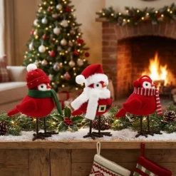 Set of three handcrafted red felt Christmas bird figurines on a cozy fireplace mantel. Wholesale holiday decor.